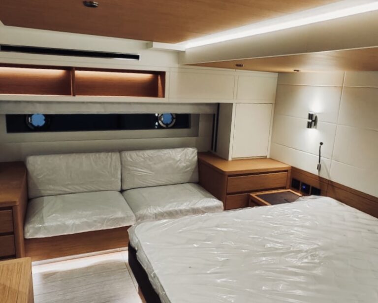 Cabin interior with fitted bed and lighting