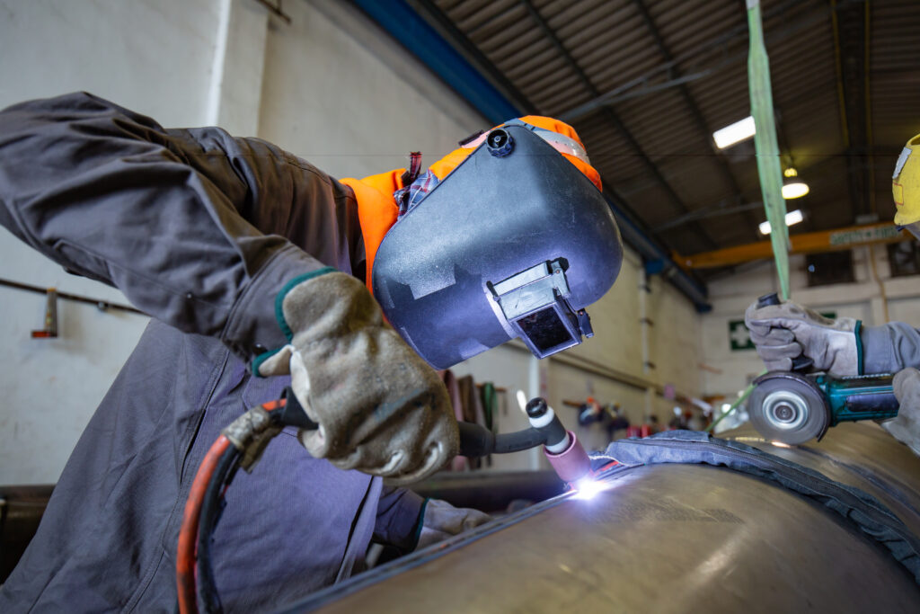 Welder working on a steel pipe