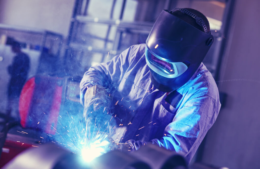 Welder in a protective mask at work