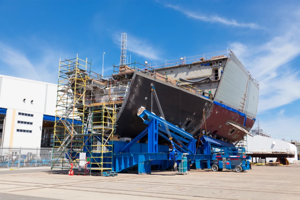 Ship hull section on a transporter at a shipyard