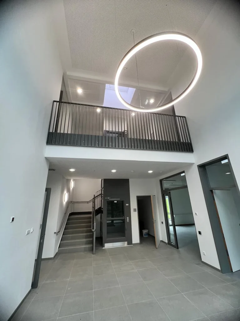 Building atrium with a ring light and steel balustrade