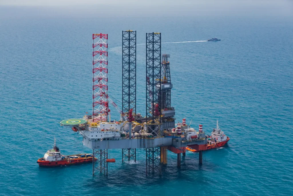 Offshore jack-up rig with support vessels