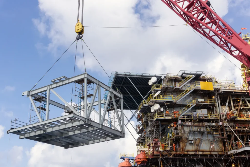 Steel module lifted by crane onto an offshore platform