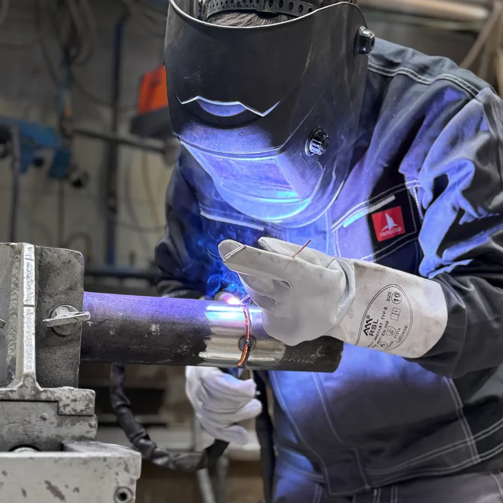 Welder joining a steel pipe