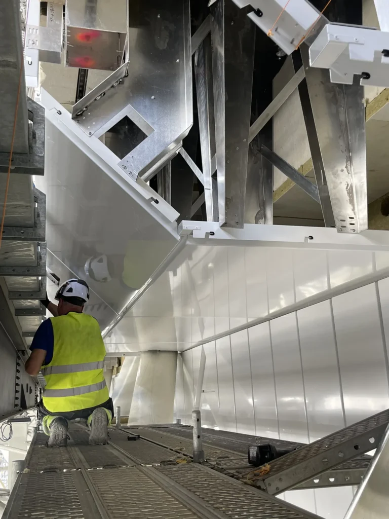 Installer working inside a ventilation facade structure