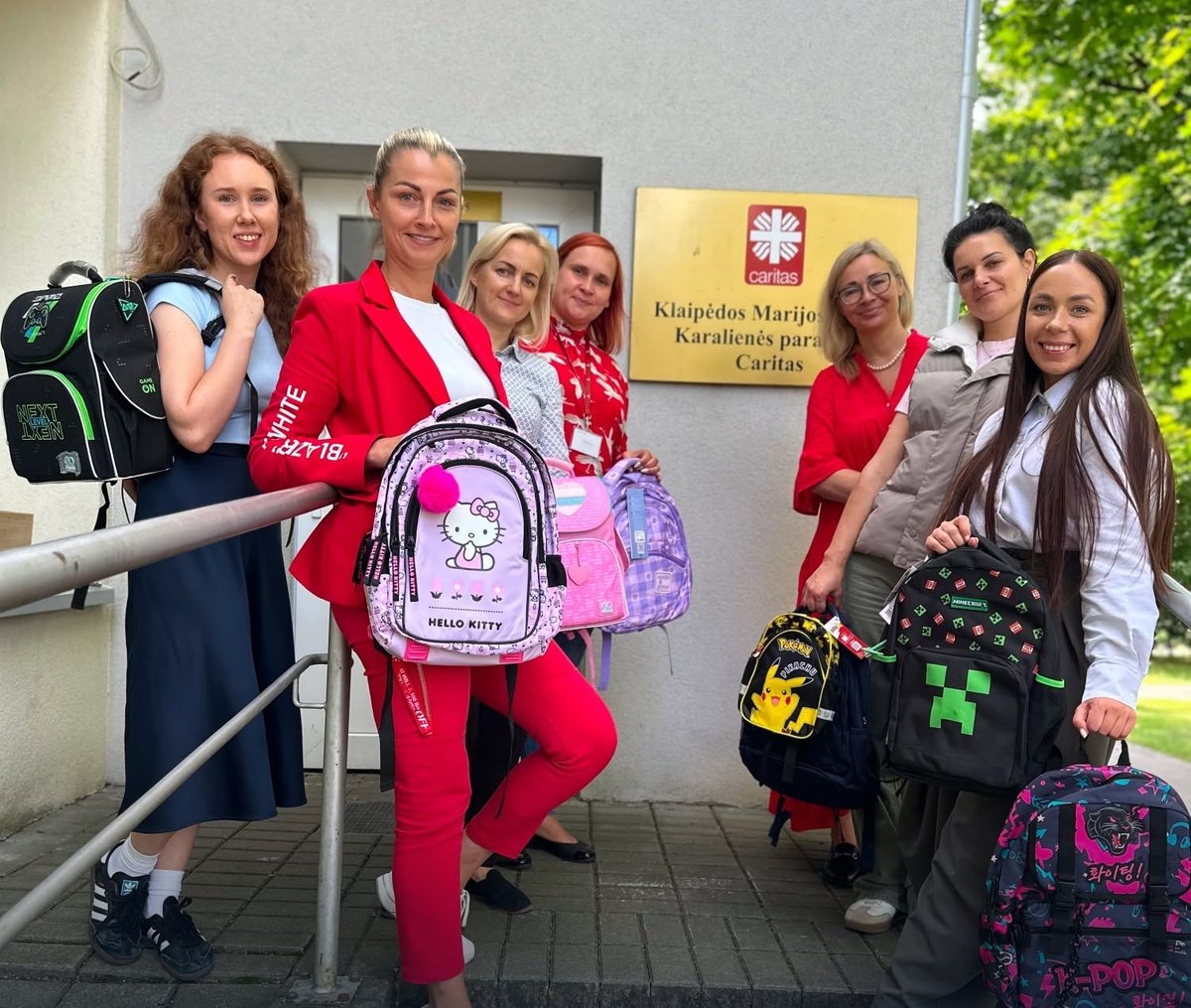 MARINO colleagues with donated backpacks for Caritas